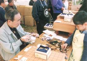 Demonstration to product carved shogi piece.