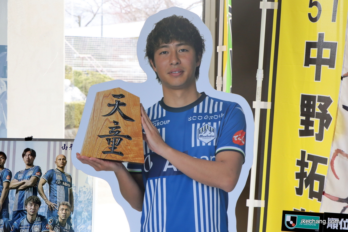 写真：将棋駒を手にした髙江麗央 選手